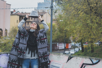 Beautiful young brunette posing in the city streets