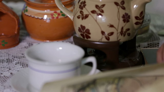 Shot of tea cups and a jar on the table