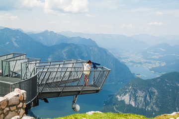 Young girl standing on the viewing platform Five Fingers. Alps. 
