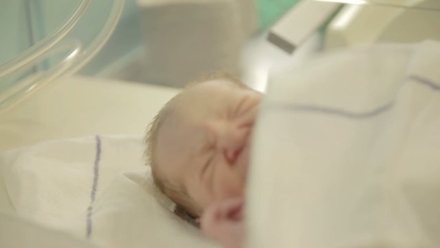Nurse cover just-born baby boy