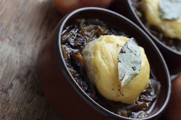 French onion soup with toast and melted cheddar on top.