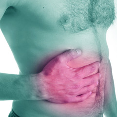 Shirtless man suffering suffering from severe abdominal pain