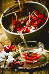 fresh berries of a guelder-rose on a wooden table.