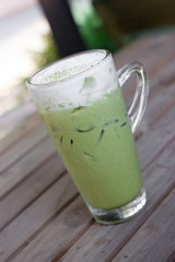 Glass of iced green tea latte.