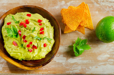 Guacamole sauce on a wooden table.