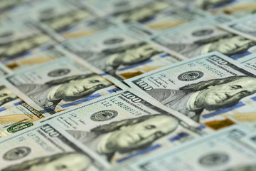Heap of US dollars in hundred notes covering the table