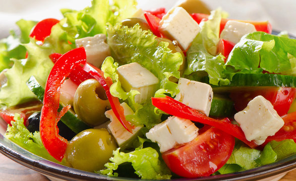 Greek  salad with feta, olives and vegetables .