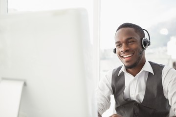 Smiling businessman with headset interacting