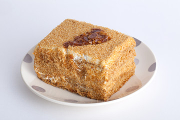 honey cake with caramel pattern on a plate