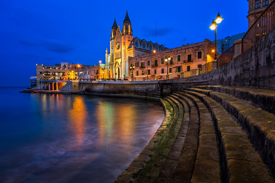 Church of Our Lady of Mount Carmel and Balluta Bay in Saint Juli