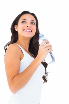 Pretty brunette drinking bottle of water