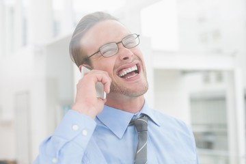 Happy businessman on the phone laughing