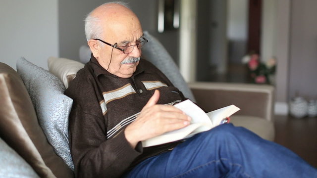 Senior Man Reading Book at Home