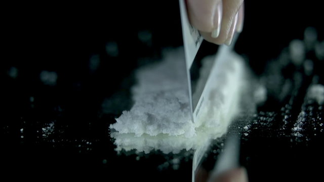 Making a couple of distinctive lines out of cocaine for sniffing