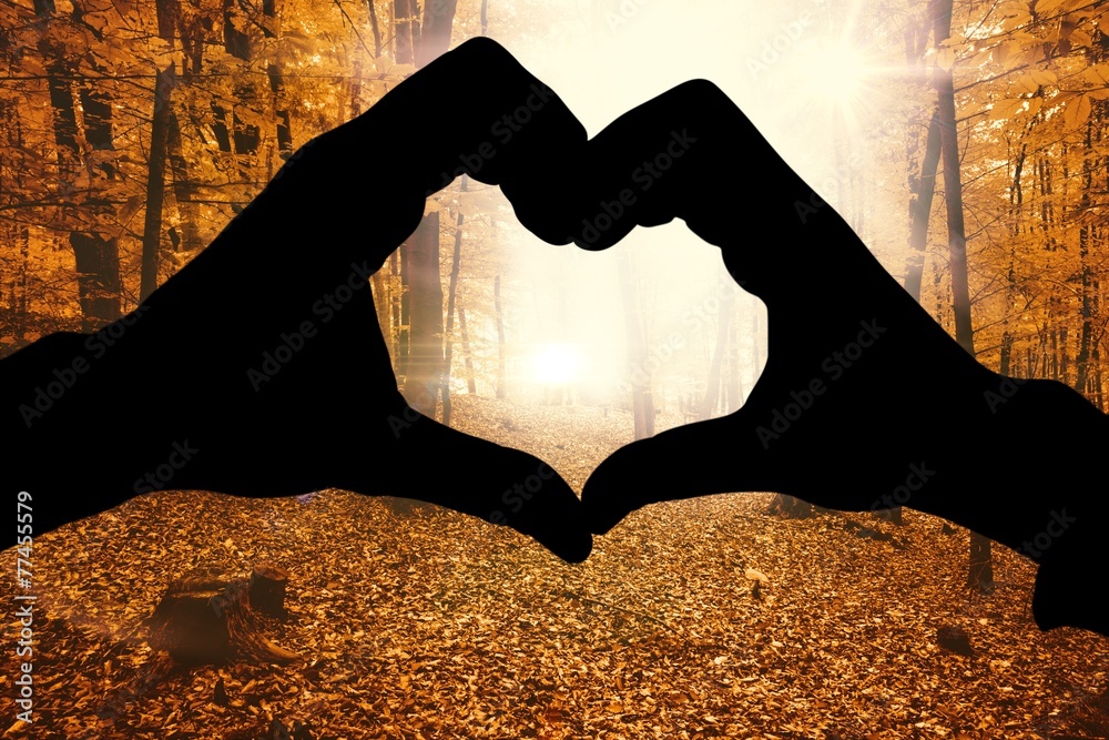 Aufkleber Composite image of couple making heart shape with hands