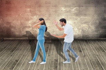 Obraz na płótnie Canvas Composite image of angry boyfriend shouting at girlfriend