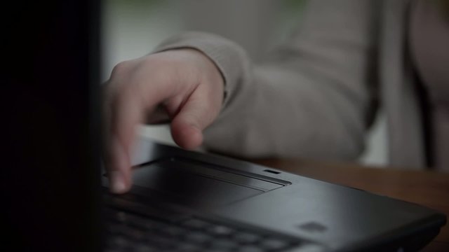 Detail shot of girl using the notes and her laptop