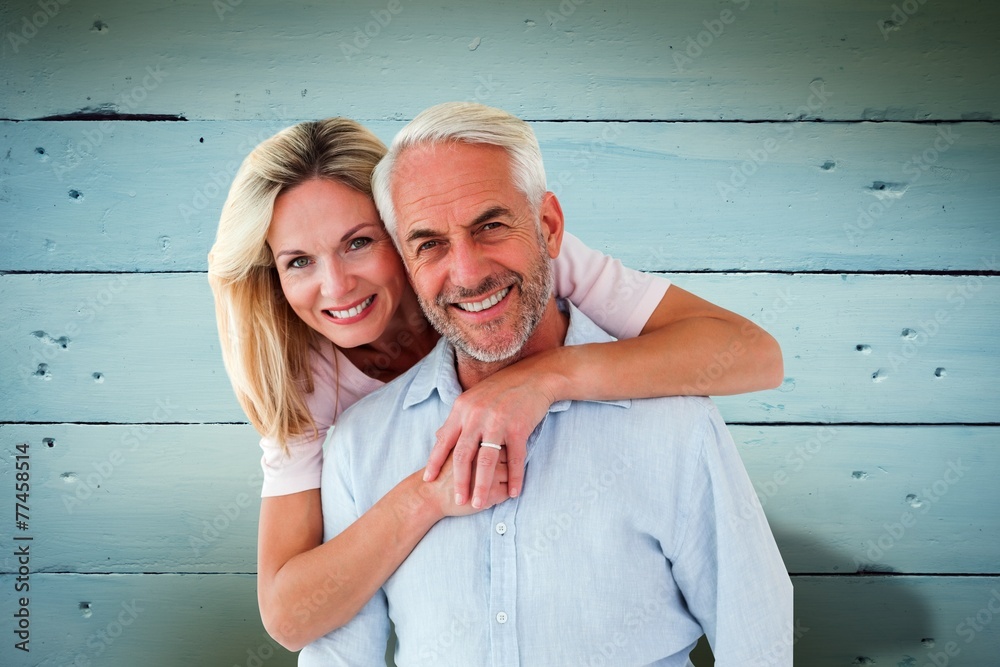 Poster smiling couple embracing and looking at camera