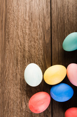 Easter eggs on wooden table background with copy space