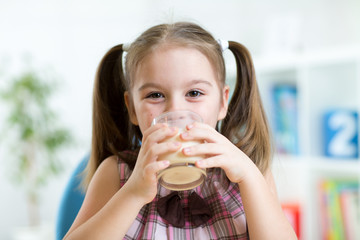 kid drinking milk from glass