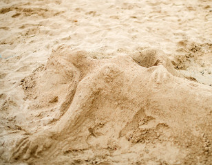 Mermaid made of sand on the beach.