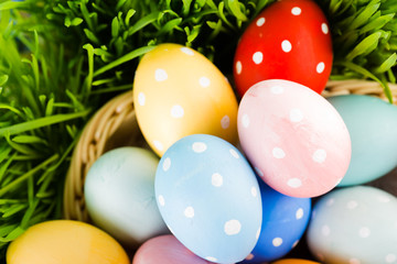 Easter eggs in basket on meadow