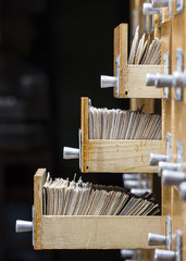 Three open drawers in the archive library on a dark background