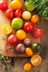 colorful tomatoes over wooden background