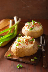 baked potato in jacket with bacon and cheese