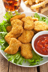 fast food chicken nuggets with ketchup, french fries, cola