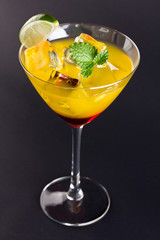 a red cocktail with orange
