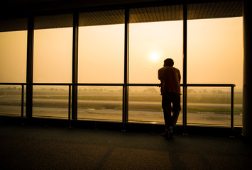 Fototapeta na wymiar Silhouette of man waiting for the flight