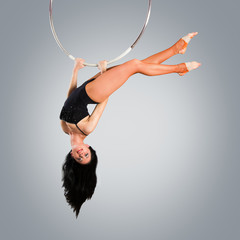 Plastic beautiful girl gymnast on acrobatic circus ring in flesh