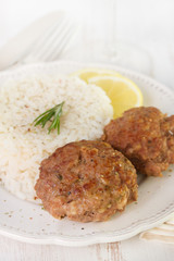meatballs with rice and lemon on plate