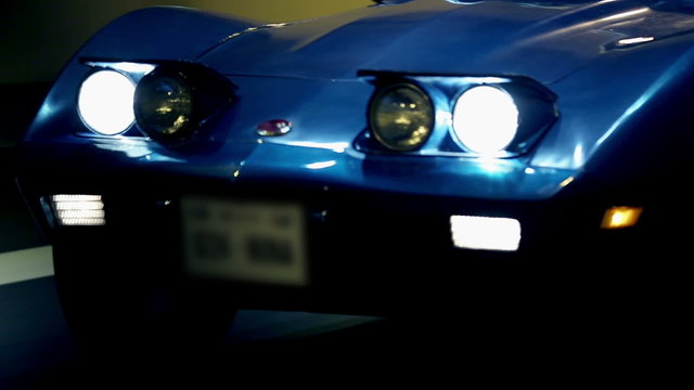 Blue car driving through a tunnel at a night drive