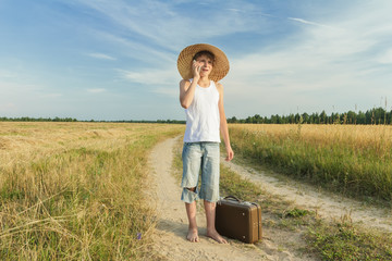 Tennage boy talking by smartphone in countryside