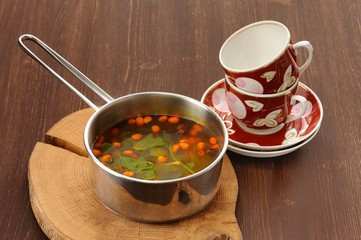 Sea-buckthorn tea with mint in stew-pan