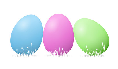 blue, pink and green easter eggs in grass