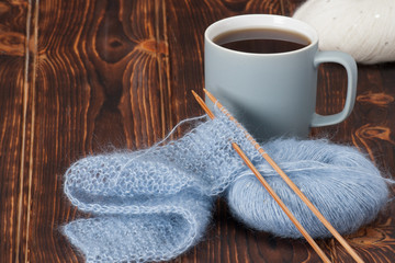 Yarn Balls. Knit Needles. Mug Of Tea. Wooden Table
