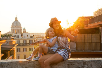 Naklejka premium Mother and baby girl sitting on street in Rome