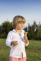 Young cute boy eating a tasty ice cream