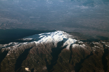 View of snow-covered mountain top from above. Apennines, Italy
