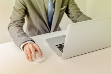 Closeup of businessman hands typing on laptop computer