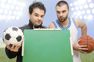 Closeup of two athletes holding blackboard,stadium background