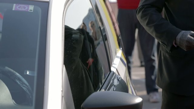 Breaking car window with hammer and gloves on fourth try