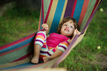 little girl resting lying on hammock