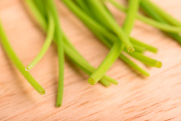  chives close up on a wooden table - selective focus