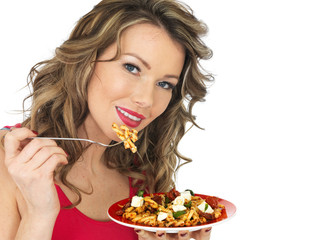 Young Woman Eating a Feta Cheese and Tommato Pasta Salad