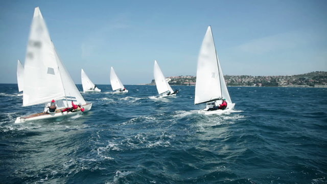 Sailboats racing to the finish line on sea
