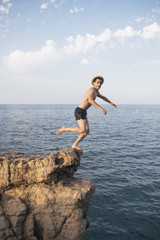 A man is dipping from a high cliff